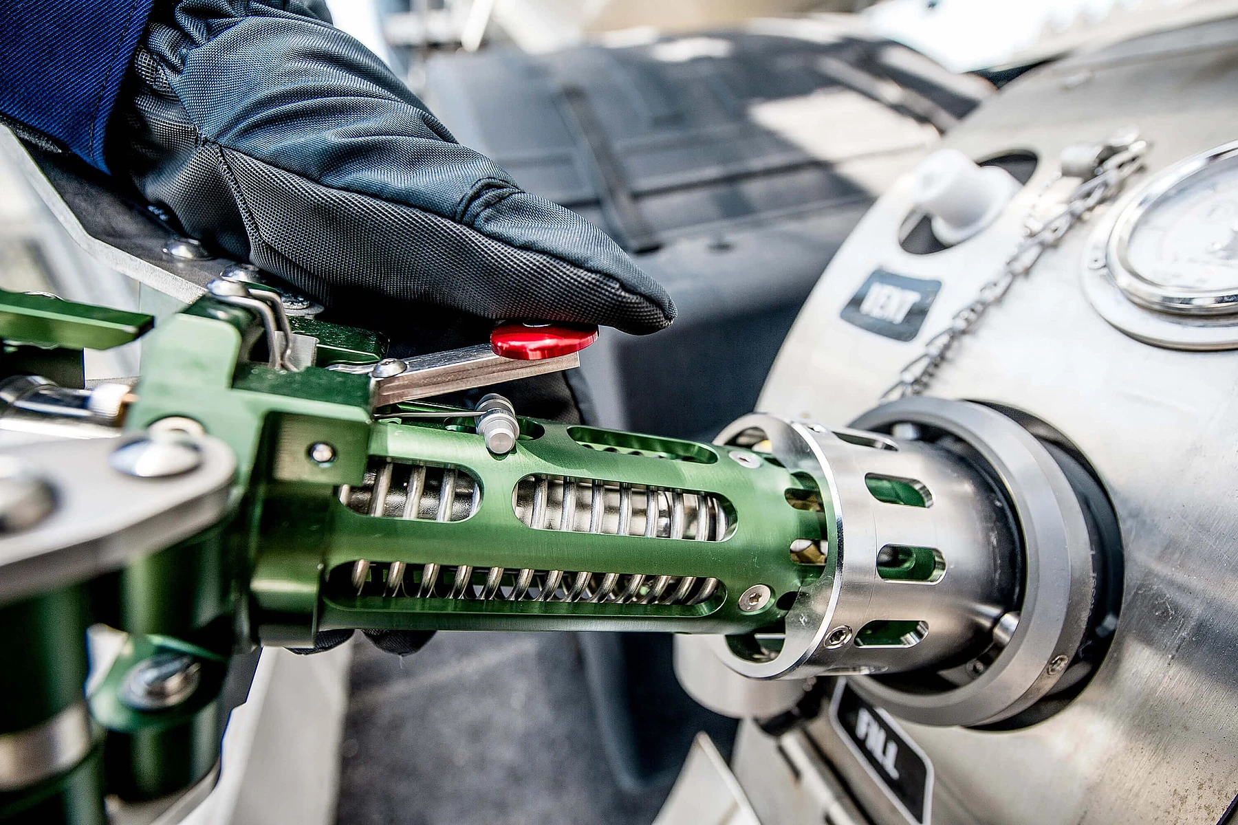 Close-up of a gloved hand refueling an LNG truck