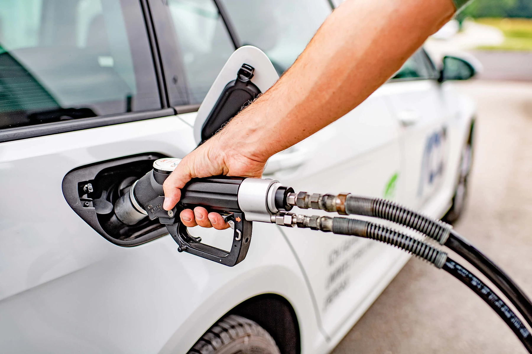 Close-up of a hand refueling a car