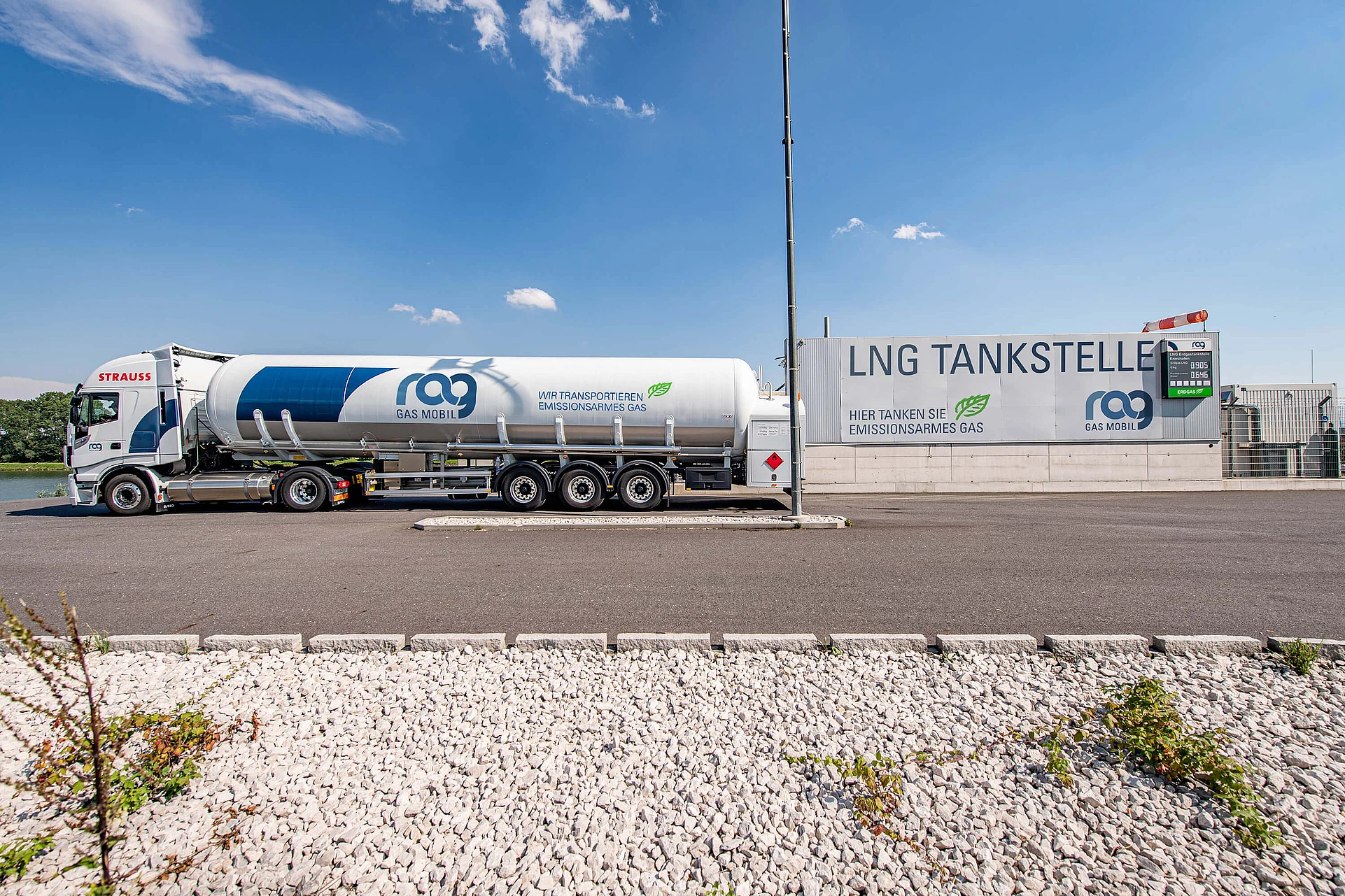 LNG truck with RAG branding in front of an LNG filling station