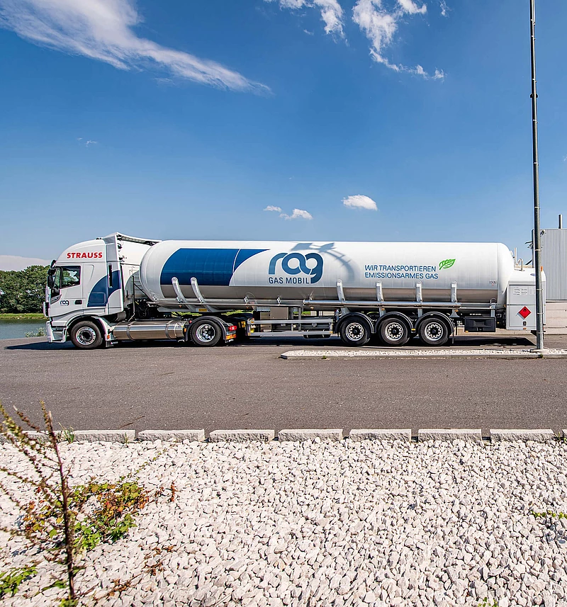 LNG truck with RAG branding in front of an LNG filling station