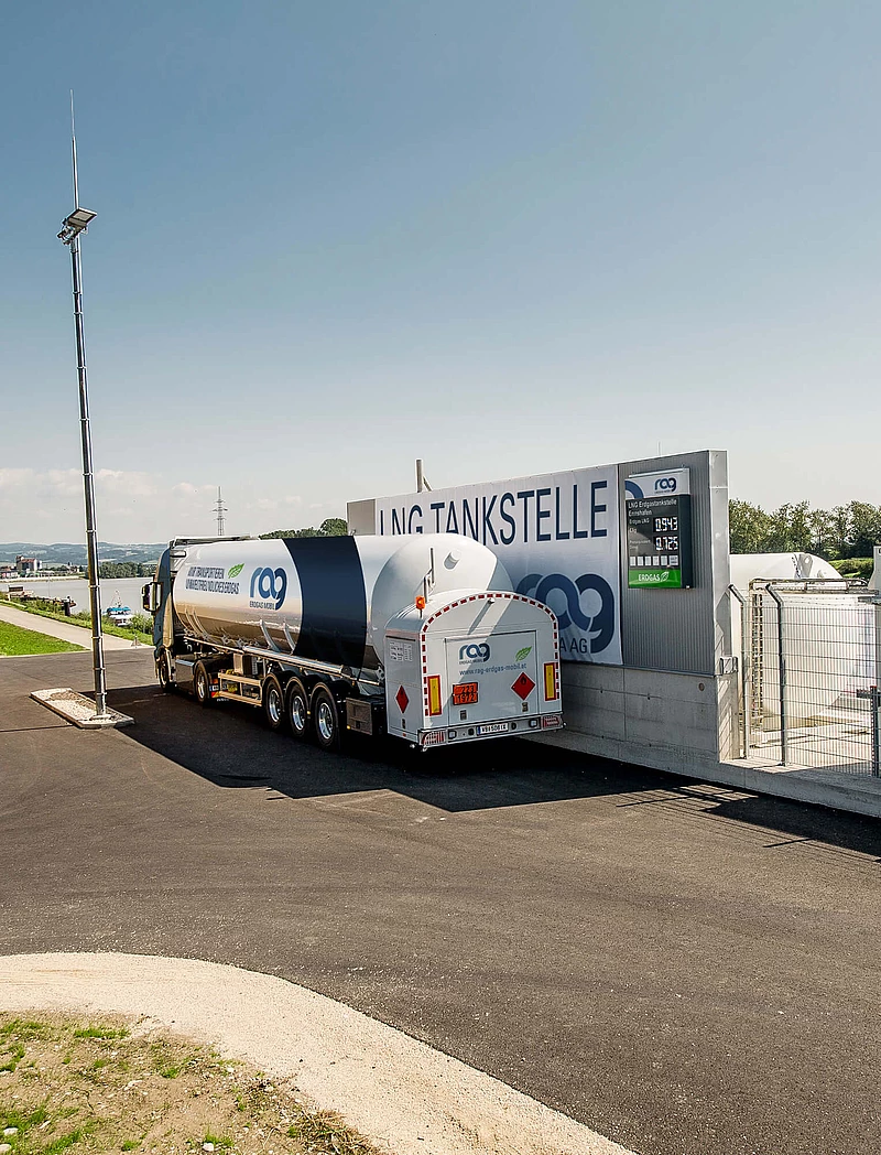 LNG truck with RAG branding seen from behind in front of RAG LNG filling station