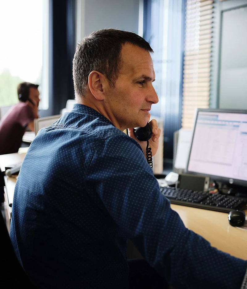 Employee talking on the phone at a desk