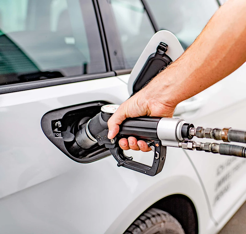 Close-up of a hand refueling a car